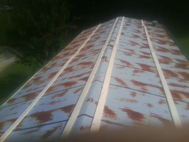 Rusted metal roof panels with new wood purlins before replacement — Storm Damage Roof Repair in Guerneville by Roofing Brothers