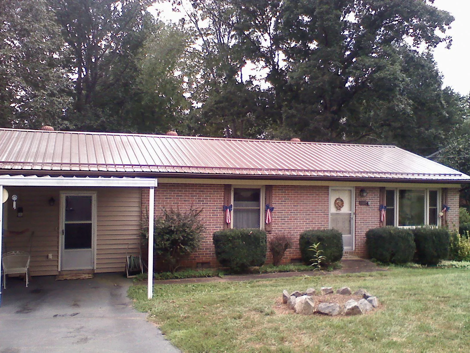 Bronze metal roof and carport on a brick ranch home — Roof Repair work by our crew in Guerneville
